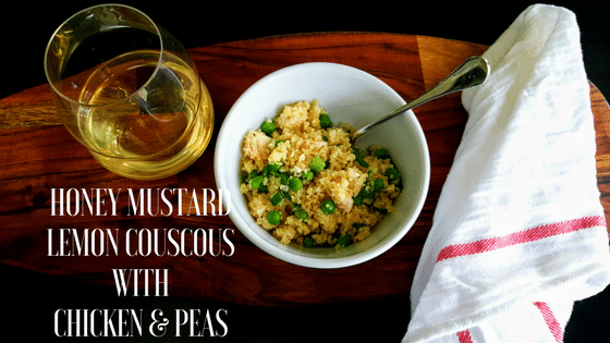 Honey Mustard Lemon Couscous with Chicken and Peas in a bowl and a glass of wine