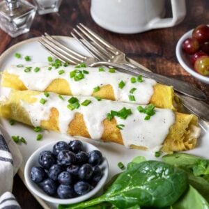 two chicken crepes topped with cream sauce