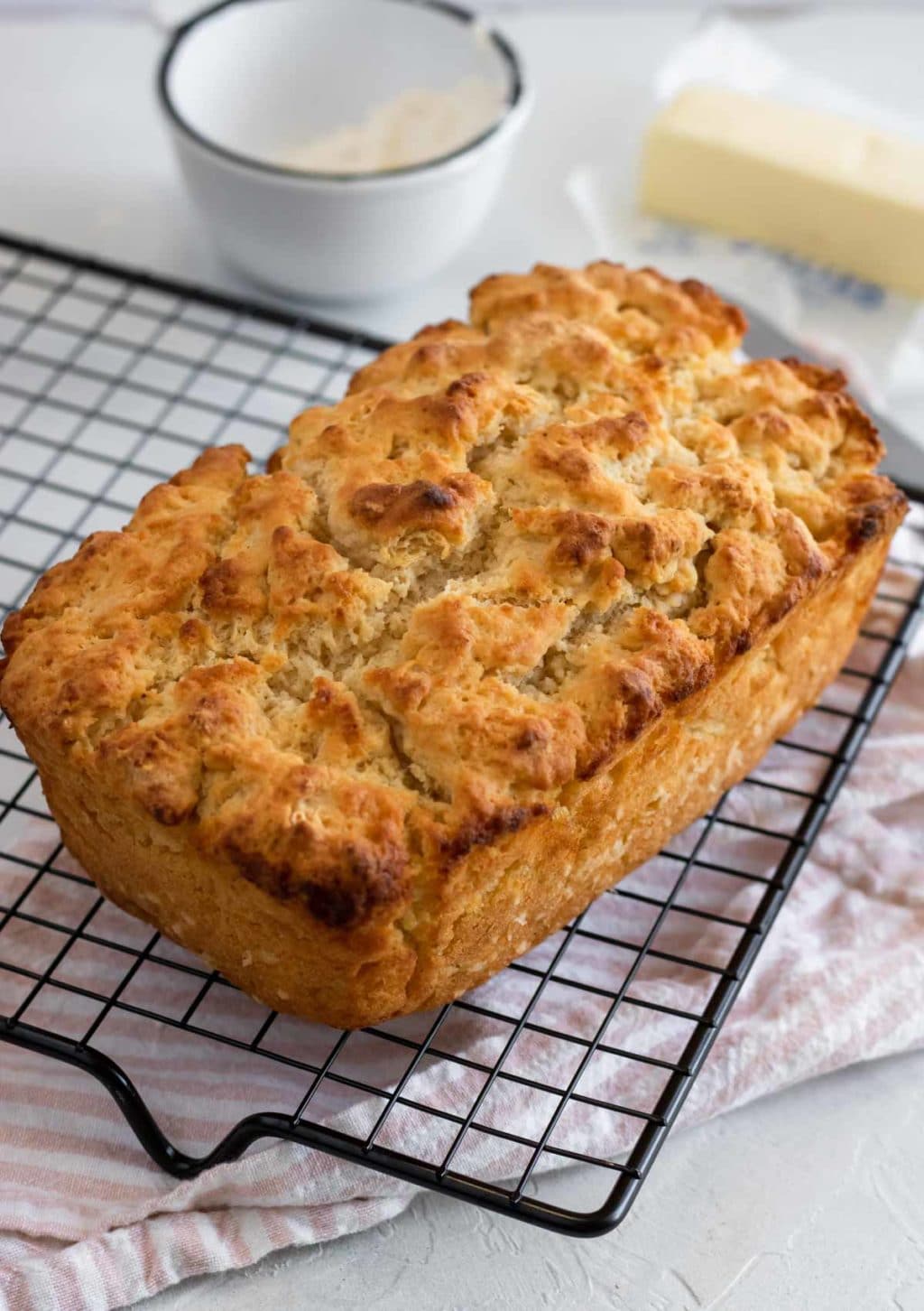 A loaf of 4 ingredient beer bread cooling on a cooling rack