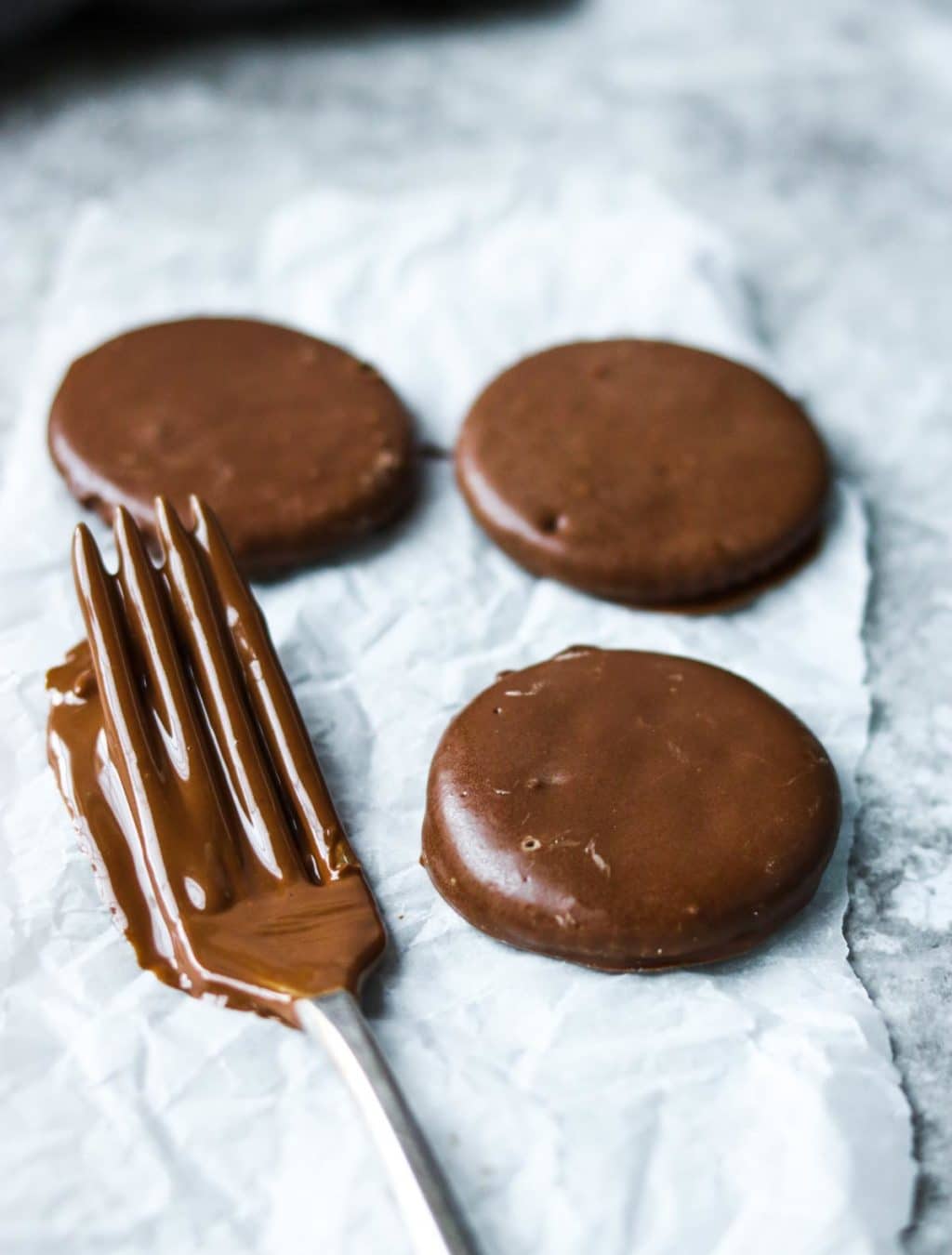 ritz cracker thin mint cookies and a fork dipped in chocolate