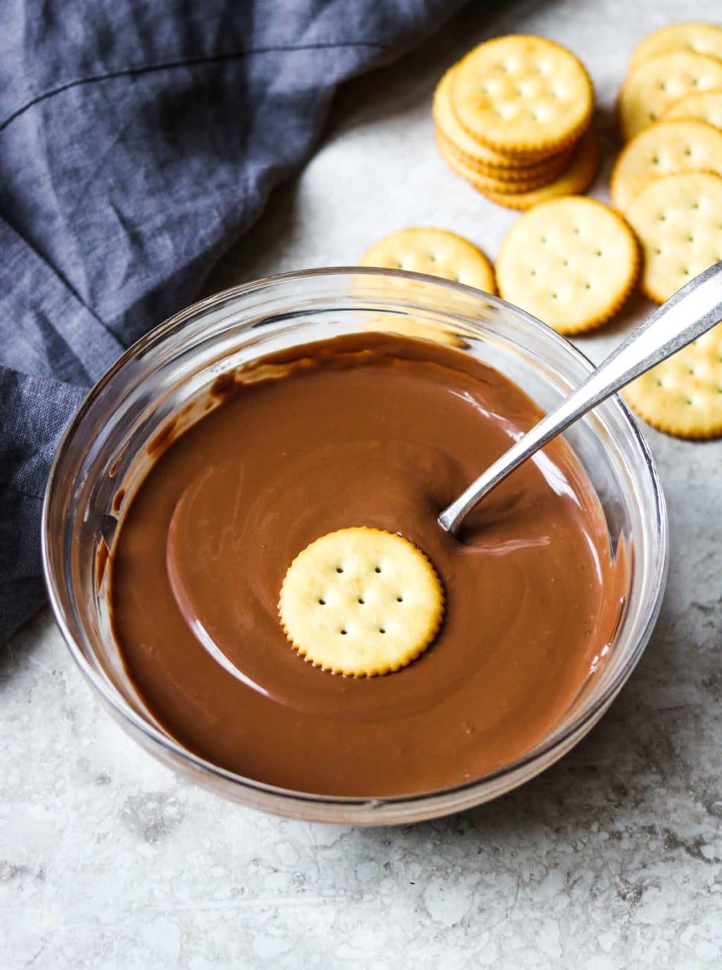 melted chocolate with a ritz cracker in the middle