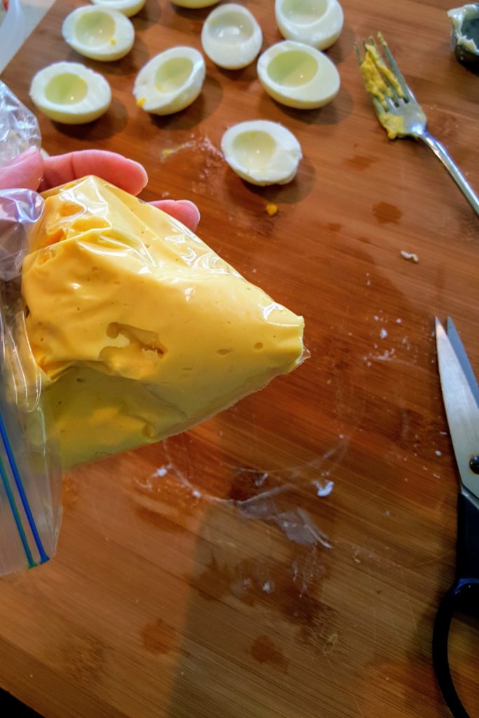 deviled egg filling in a disposable piping bag