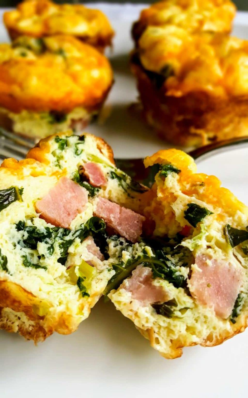 Ham and Kale Egg Cup split in half showing the ham and kale inside