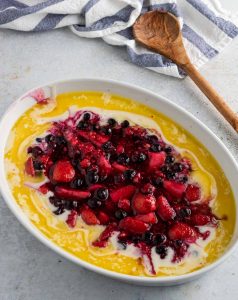 Step 3- the mixed berries are poured on top of the butter and batter