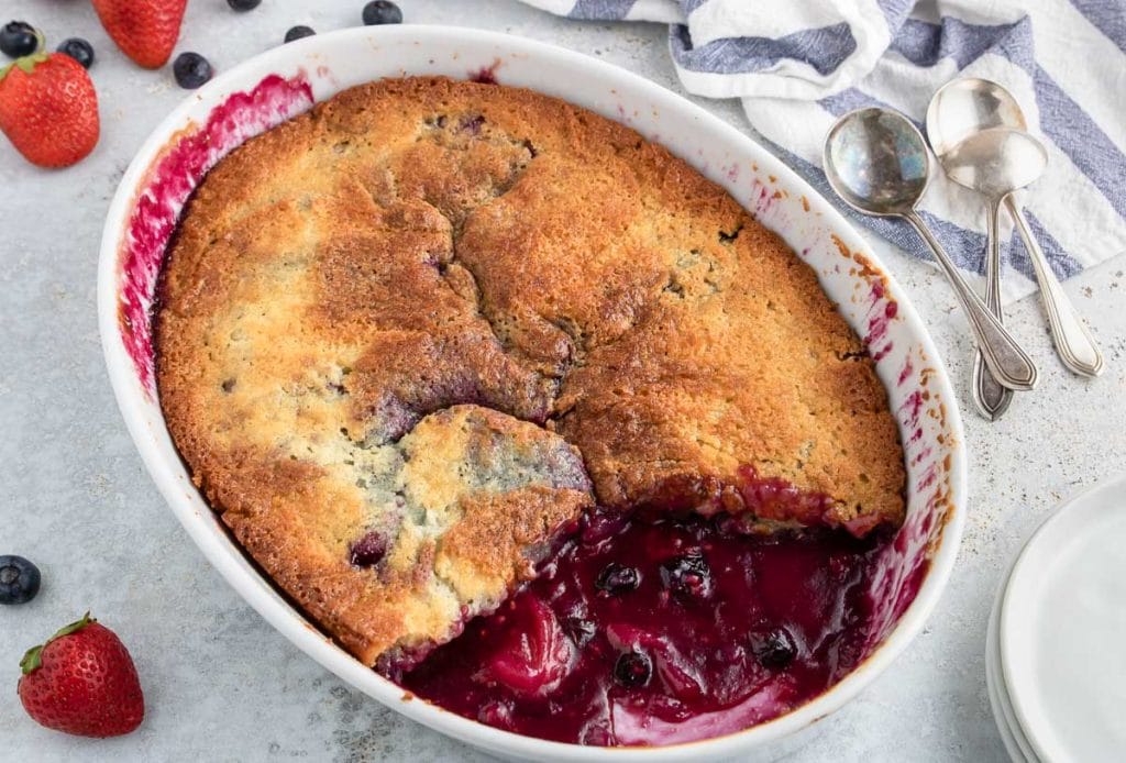 Fruit Cobbler with a slice taken out so you can see the cooked mixed berries