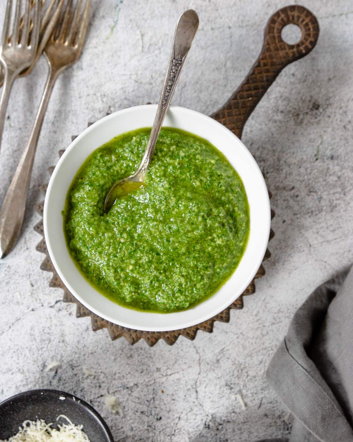a bowl of fresh pesto with a spoon
