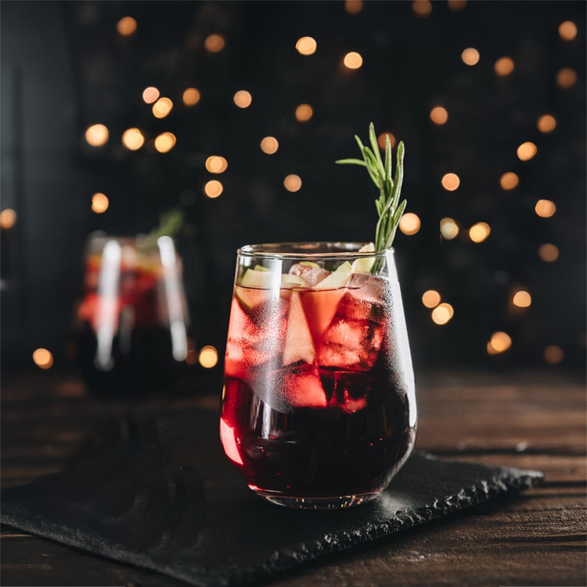 winter sangria with red wine in a glass garnished with rosemary