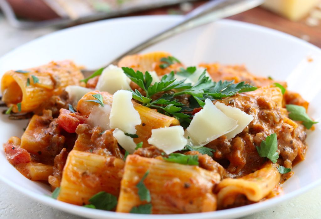 Instant Pot Rigatoni with tomato cream sauce in a bowl with parsley and parmesan