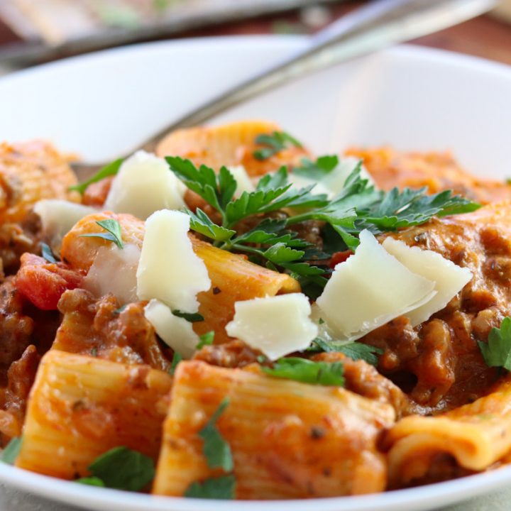 Sausage Rigatoni with tomato cream sauce in a bowl with parsley and parmesan