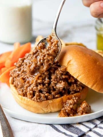 homemade sloppy joe's being heaped on a bun