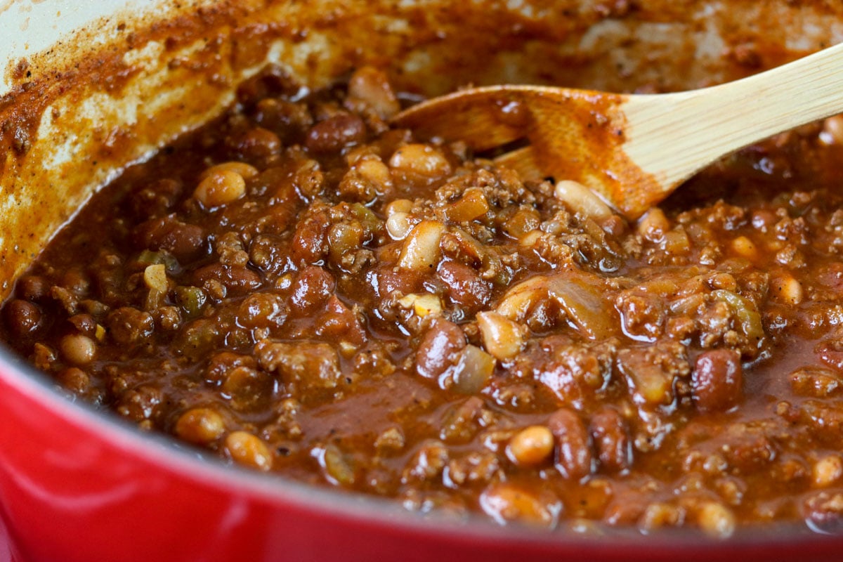 chili in a pot with a wooden spoon