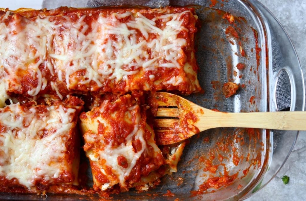 a pan of baked lasagna roll ups 