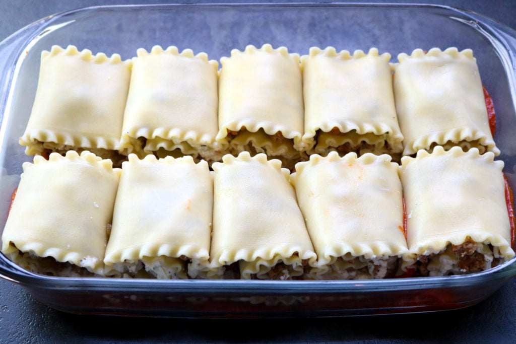 The lasagna roll ups in a glass baking pan, before the marinara is poured on top www.momsdinner.net