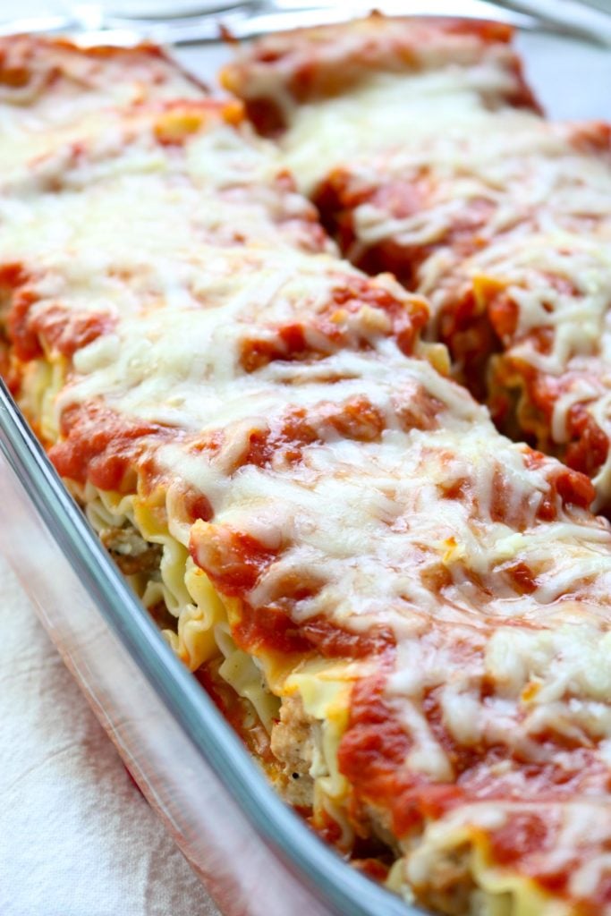 A glass baking dish full of lasagna roll ups after they are baked www.momsdinner.net