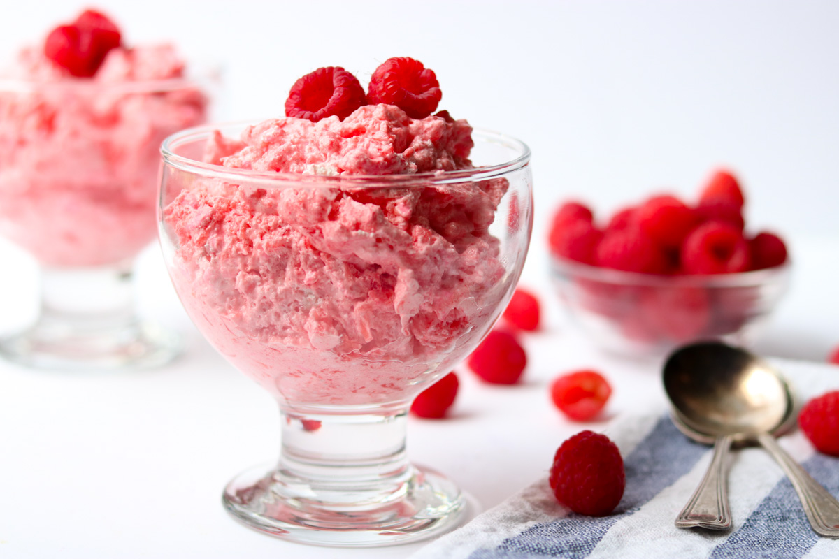 Raspberry Jello Fluff in a glass dessert cup, fresh raspberries on top momsdinner.net