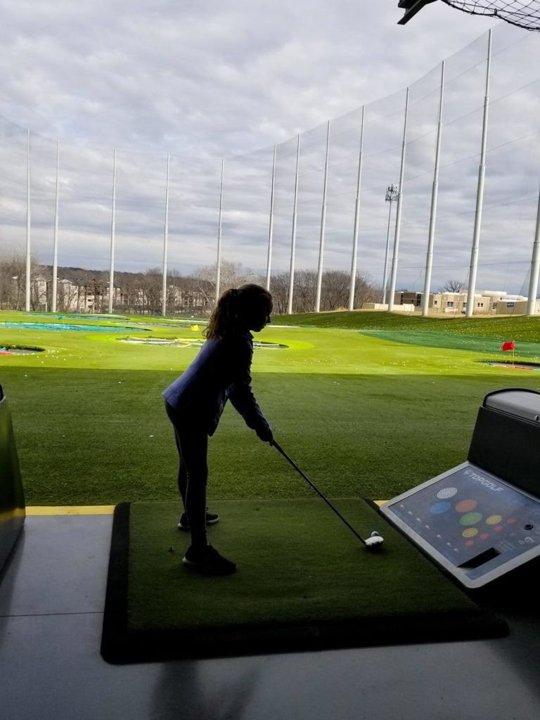 a girl golfing