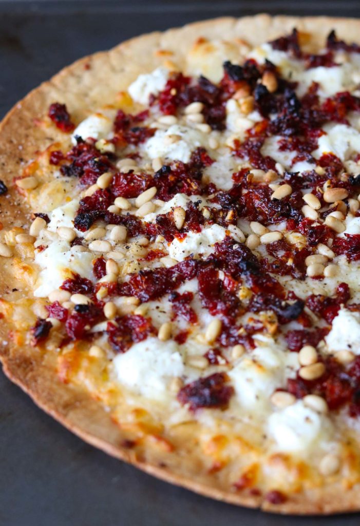Goat Cheese Pizza with Sun Dried Tomatoes and Pine Nuts straight out of the oven momsdinner.net