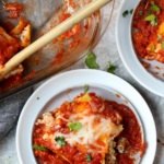 lasagna roll ups being served on white plates