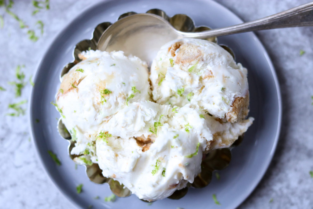 No Churn Key Lime Ice Cream in a silver dish with a spoon 