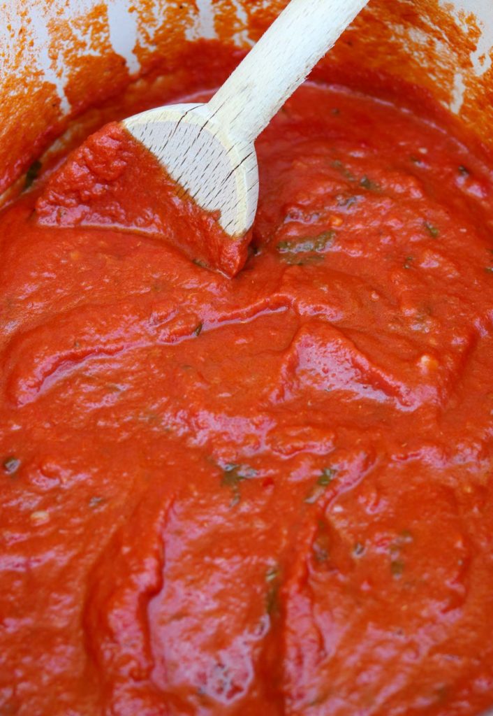Easy Homemade Marinara Sauce in a pot with a wooden spoon