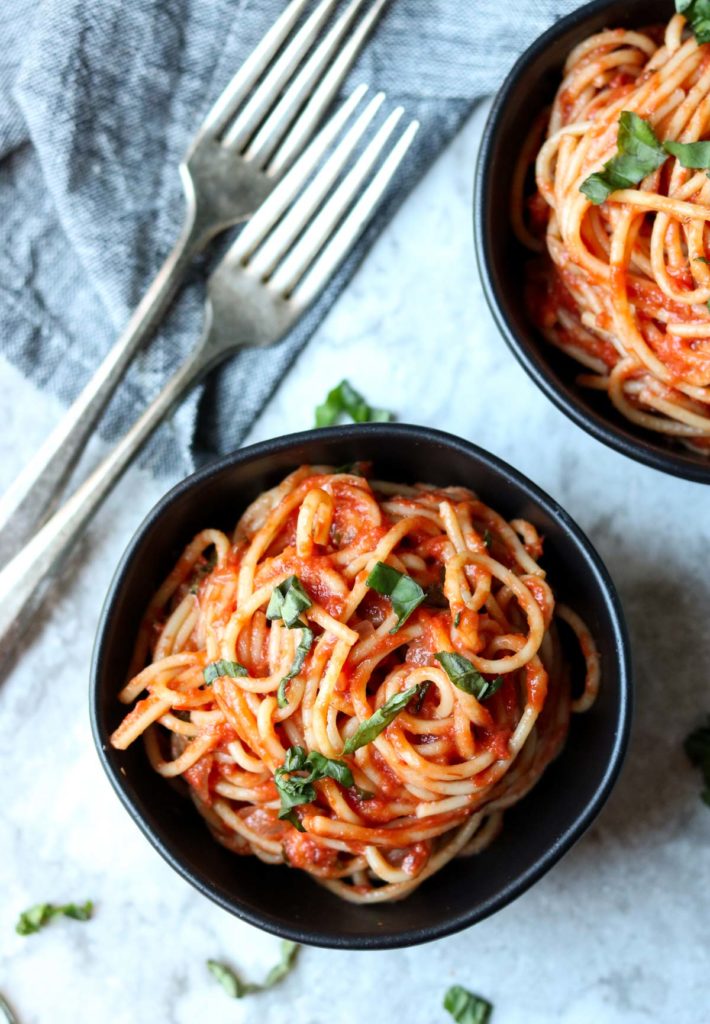 Easy Homemade Marinara Sauce on spaghetti in a black bowl with two forks to the side