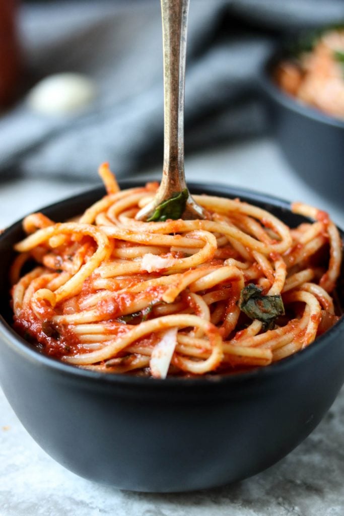 Easy Homemade Marinara Sauce on spaghetti in a black bowl with a fork