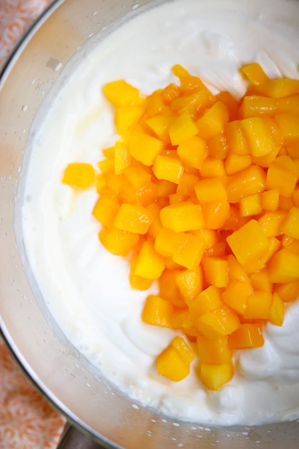 ice cream base in a bowl topped with mango