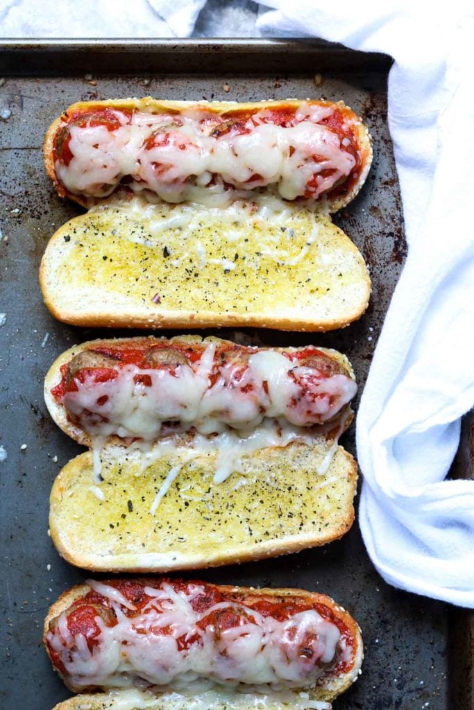 Three meatball sub sandwiches with melted cheese