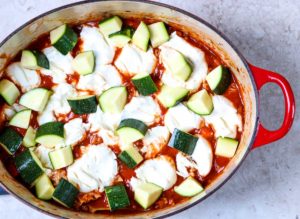 steps for making dutch oven lasagna, topped with zucchini and ricotta