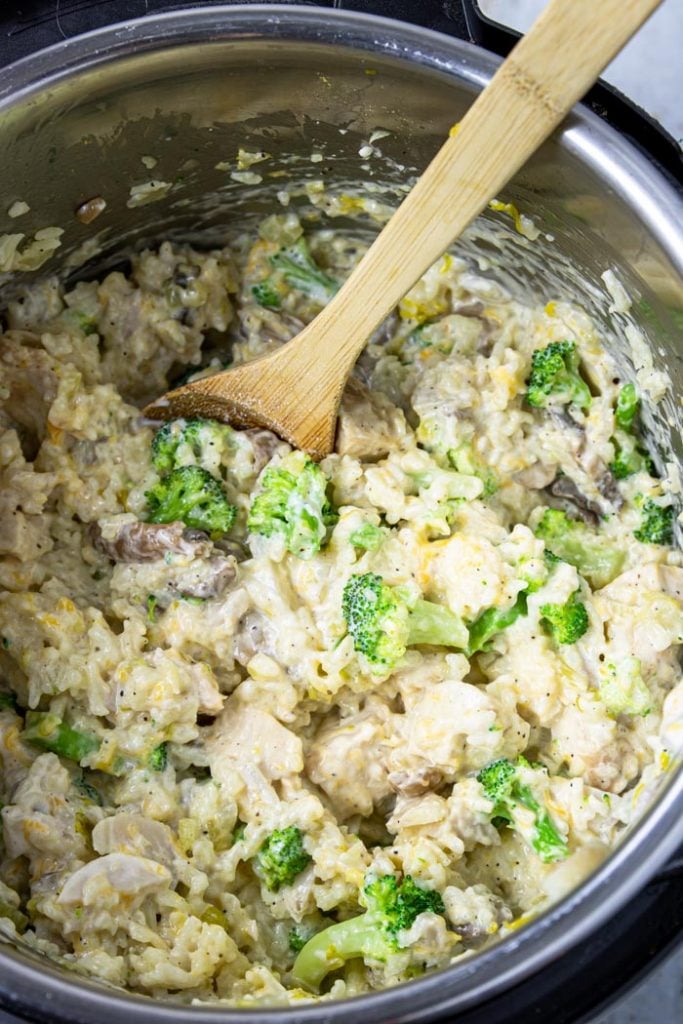 Instant Pot full of cheesy chicken and rice with broccoli and water chestnuts