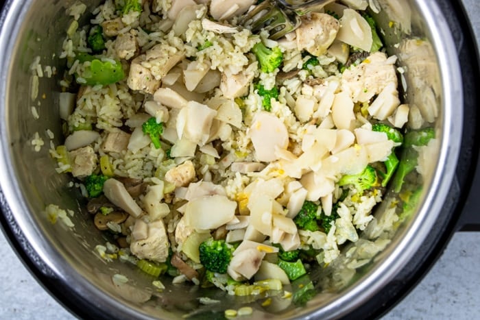 Instant Pot with broccoli, rice, chicken, water chestnuts, and mushrooms cooked inside