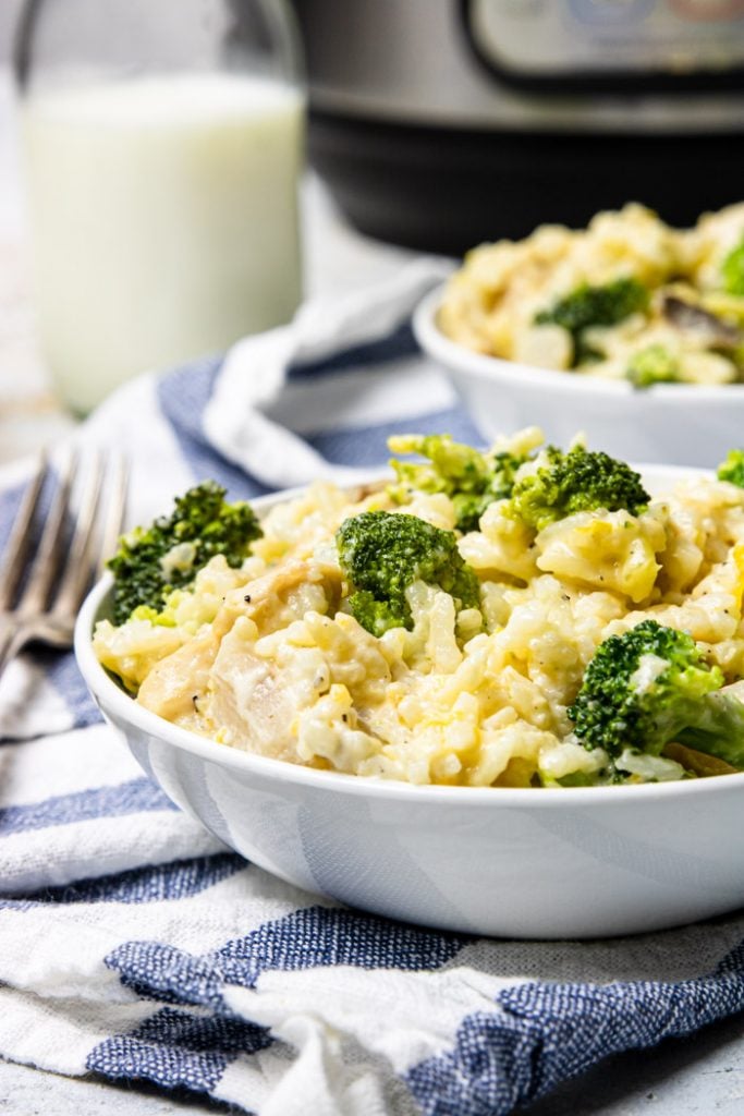 white bowl of Instant Pot Cheesy Chicken and Rice with Broccoli