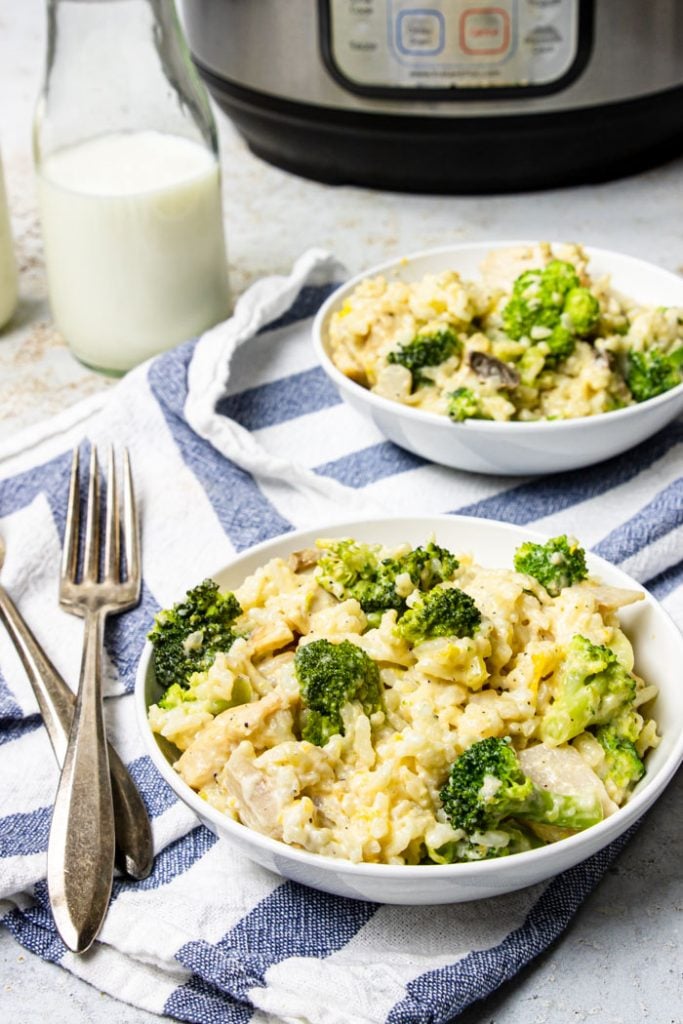 Two bowls of Instant Pot Chicken and Rice with an Instant Pot in the background