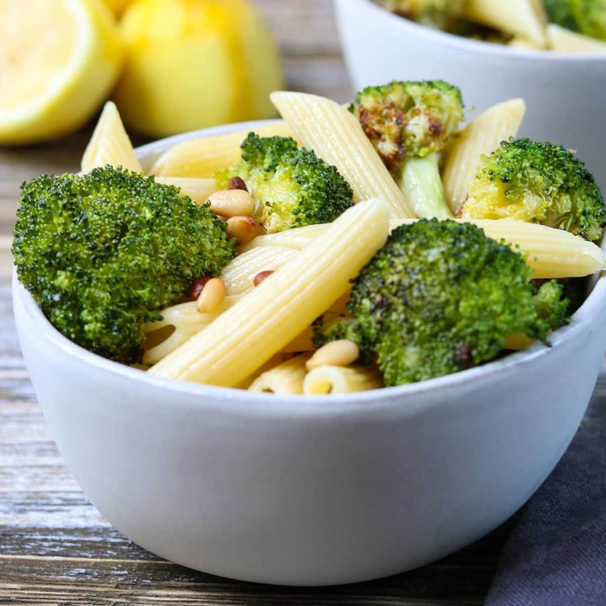 a white bowl with lemon broccoli pasta