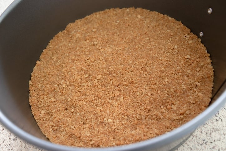 a graham cracker crust in a springform pan