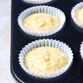 banana muffin batter in a muffin tin