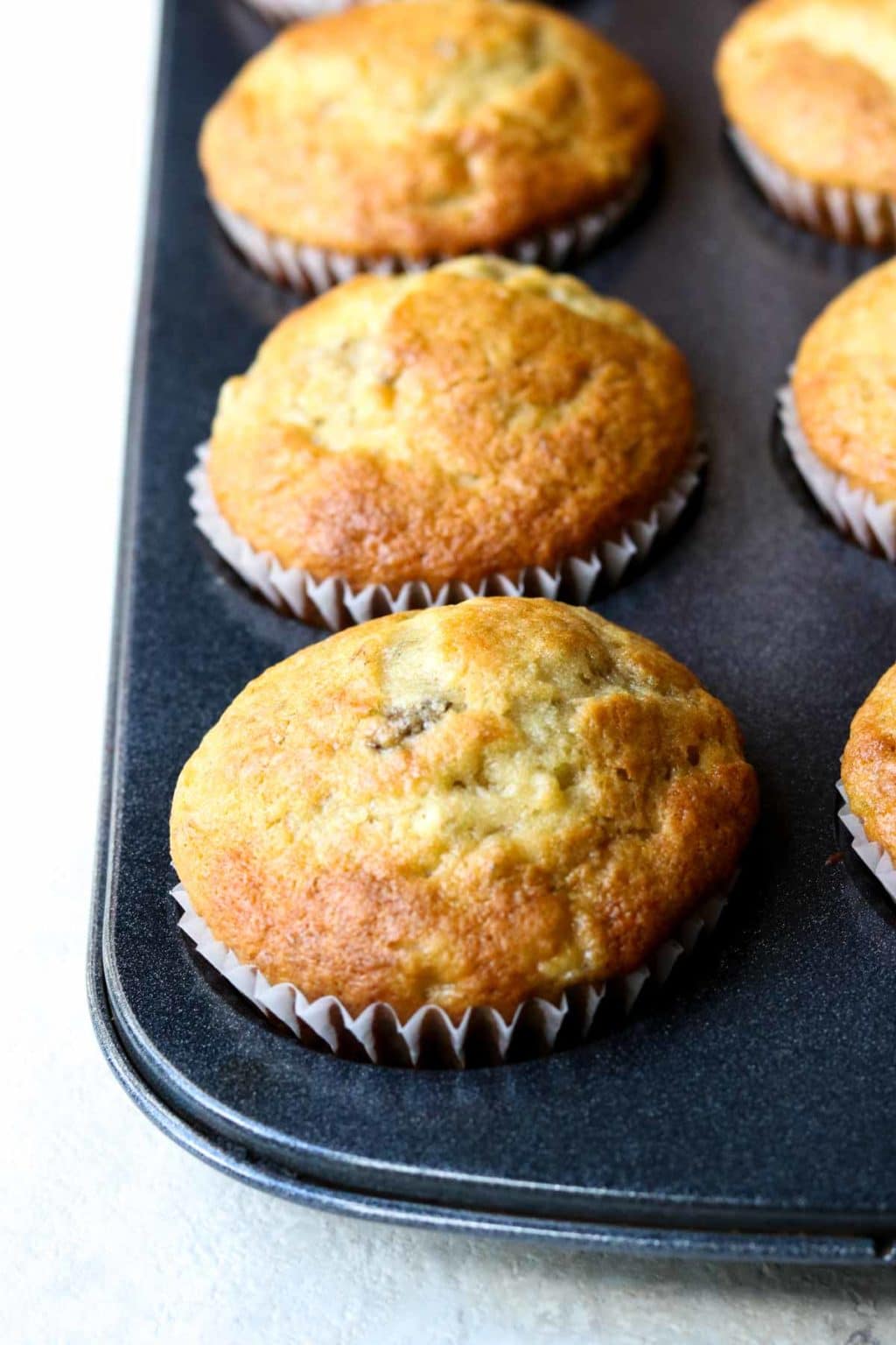 Cooked banana bread muffins in a muffin tin