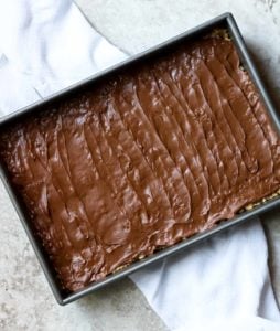 scotcheroo bars with frosting over top