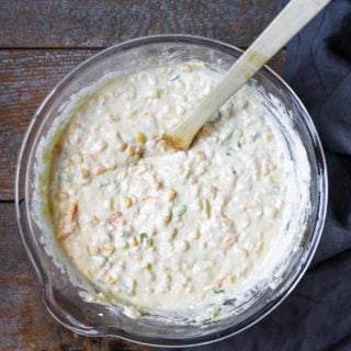 a large bowl that has the ingredients for corn casserole all stirred together.