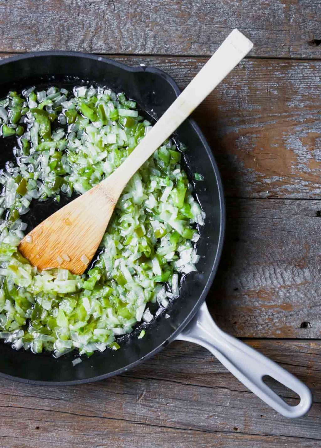 Onions and green peppers in a saute pan