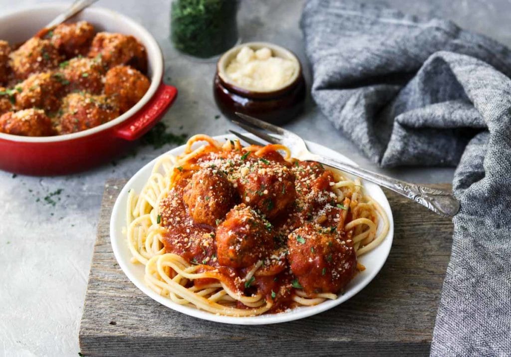 a plate of spaghetti topped with meatballs