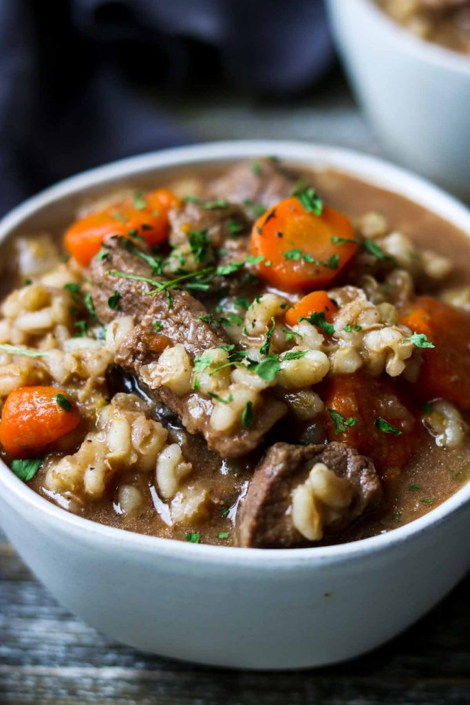 white bowl of beef and barley soup