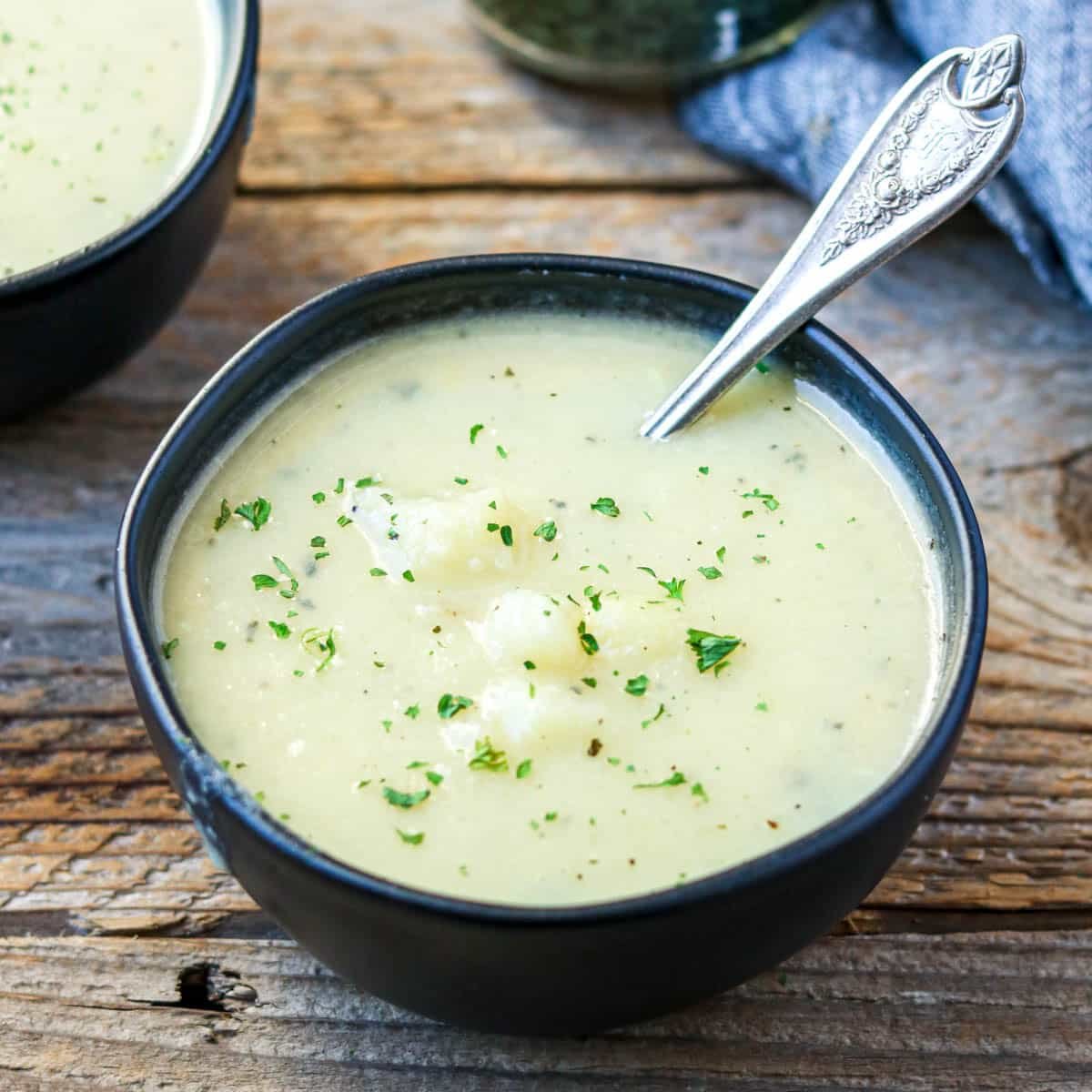 a bowl of creamy potato soup with a spoon