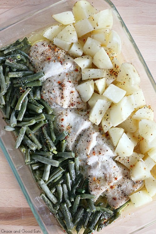 A glass baking dish with chicken green beans and potatoes