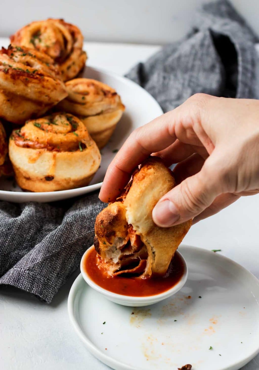 Pizza Roll Up being dipped in marinara sauce