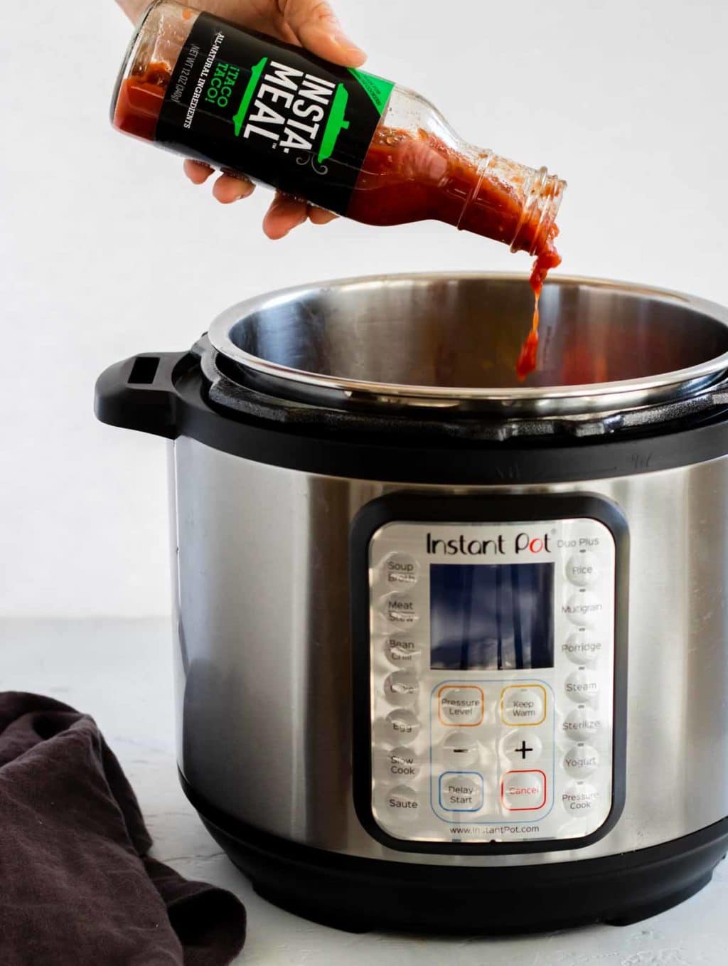 Insta-Meal Taco Taco sauce being poured into the Instant Pot