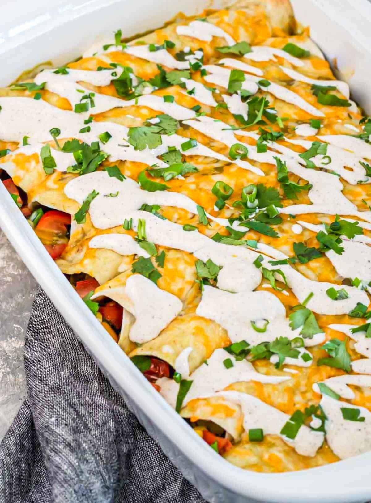 vegetarian enchiladas topped with cheese, green onions and chili lime crema