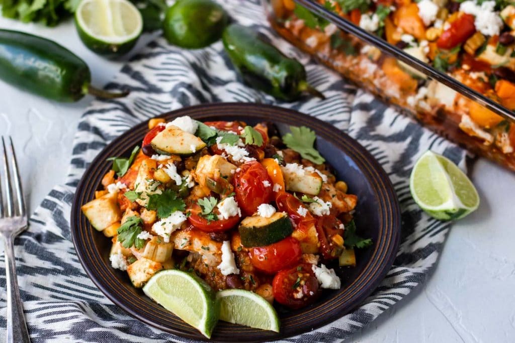 Mexican Chicken and Rice on a plate garnished with limes