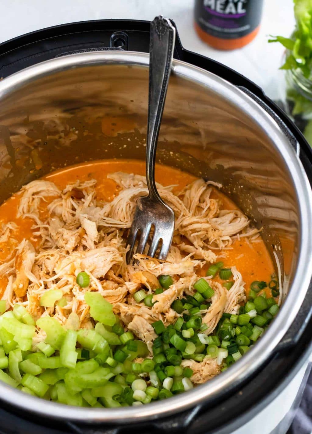 Chicken, celery, green onions, and buffalo sauce in the instant pot