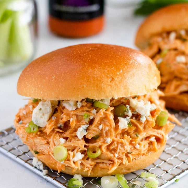 Buffalo Chicken Sandwiches topped with blue cheese crumbles and green onions